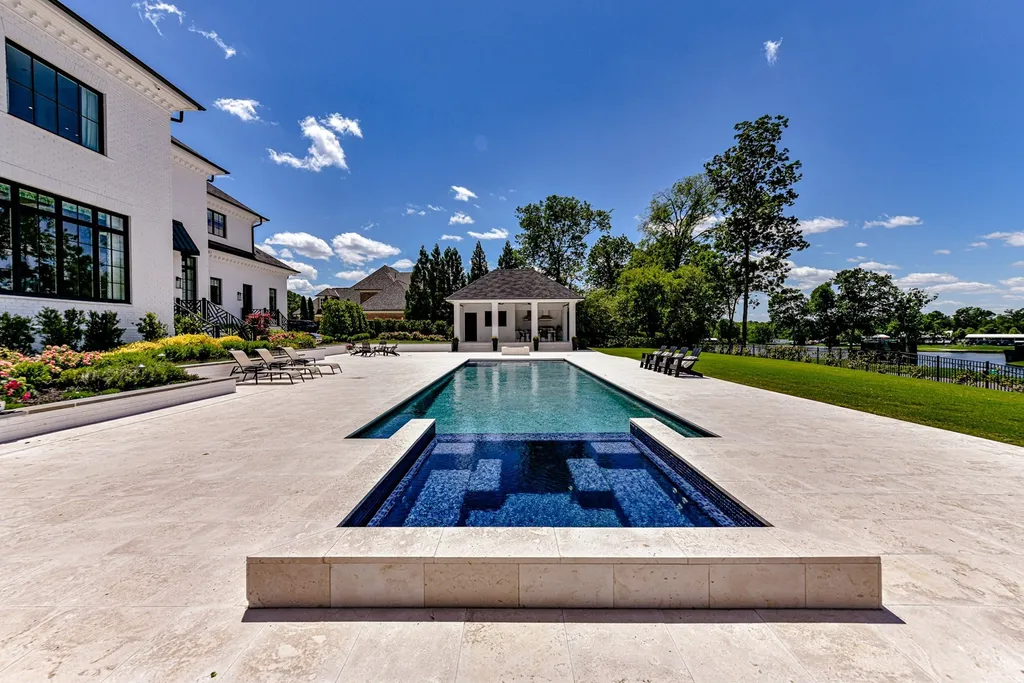 7214 Baltusrol Lane Home in Charlotte, North Carolina. Recently renovated with custom details, including Canadian Black Walnut hardwoods and Italian Calacatta marble, this home exudes elegance. The chef's kitchen, luxurious primary suite, and outdoor entertainment area with a pool and fireplace make this home the epitome of luxury. With a 3-car garage and golf cart bay, it caters to every need. Don't miss this opportunity to own a truly remarkable property.