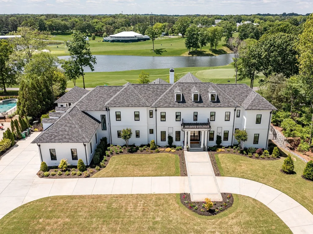 7214 Baltusrol Lane Home in Charlotte, North Carolina. Recently renovated with custom details, including Canadian Black Walnut hardwoods and Italian Calacatta marble, this home exudes elegance. The chef's kitchen, luxurious primary suite, and outdoor entertainment area with a pool and fireplace make this home the epitome of luxury. With a 3-car garage and golf cart bay, it caters to every need. Don't miss this opportunity to own a truly remarkable property.