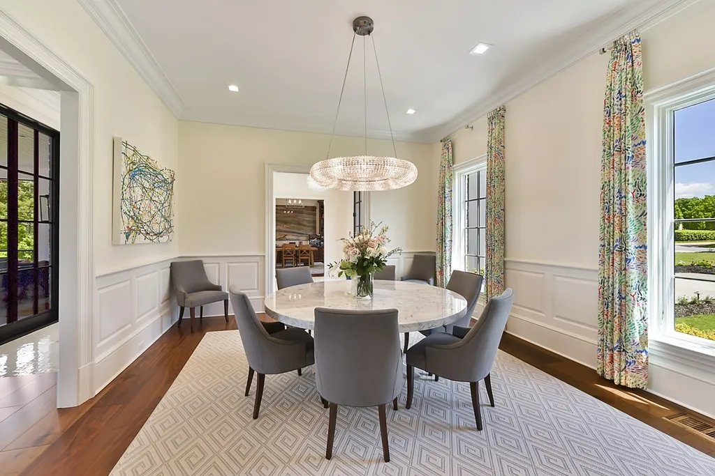 7214 Baltusrol Lane Home in Charlotte, North Carolina. Recently renovated with custom details, including Canadian Black Walnut hardwoods and Italian Calacatta marble, this home exudes elegance. The chef's kitchen, luxurious primary suite, and outdoor entertainment area with a pool and fireplace make this home the epitome of luxury. With a 3-car garage and golf cart bay, it caters to every need. Don't miss this opportunity to own a truly remarkable property.