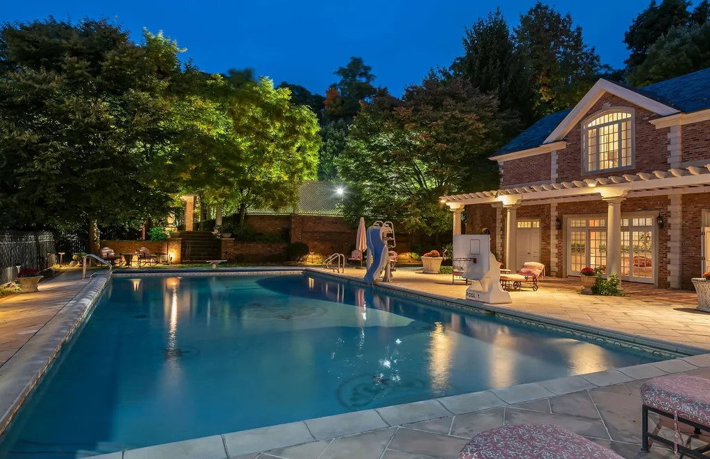 887 Closter Dock Road Home in Alpine, New Jersey. This extraordinary architectural triumph harmoniously blends classic European design with a contemporary touch. Set within an expansive 8-acre property, this magnificent home boasts approximately 35,000 sqft of living space, including the lower level. Prepare to be captivated by the grandeur of the dramatic foyer, generously sized rooms, and an abundance of natural light throughout. With 10 spacious bedroom en suites, 17 bathrooms, a chef's kitchen, formal dining room, family room, and a spectacular great room with a custom bar, every corner of this estate exudes luxury. 