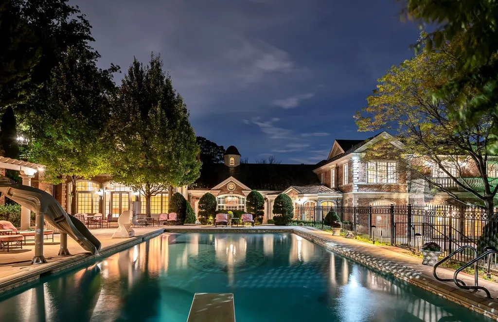 887 Closter Dock Road Home in Alpine, New Jersey. This extraordinary architectural triumph harmoniously blends classic European design with a contemporary touch. Set within an expansive 8-acre property, this magnificent home boasts approximately 35,000 sqft of living space, including the lower level. Prepare to be captivated by the grandeur of the dramatic foyer, generously sized rooms, and an abundance of natural light throughout. With 10 spacious bedroom en suites, 17 bathrooms, a chef's kitchen, formal dining room, family room, and a spectacular great room with a custom bar, every corner of this estate exudes luxury. 