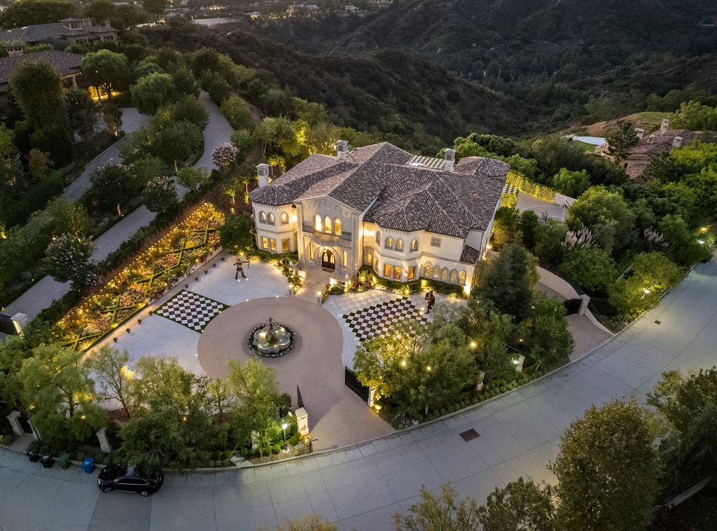 9 Beverly Ridge Terrace Home in Beverly Hills, California. Nestled behind double guard gates in the prestigious Beverly Ridge Estates, this custom-built Italian Romanticism-inspired home boasts modern-day conveniences while showcasing the intricately designed craftsmanship of renowned architect, Robert Rivani.