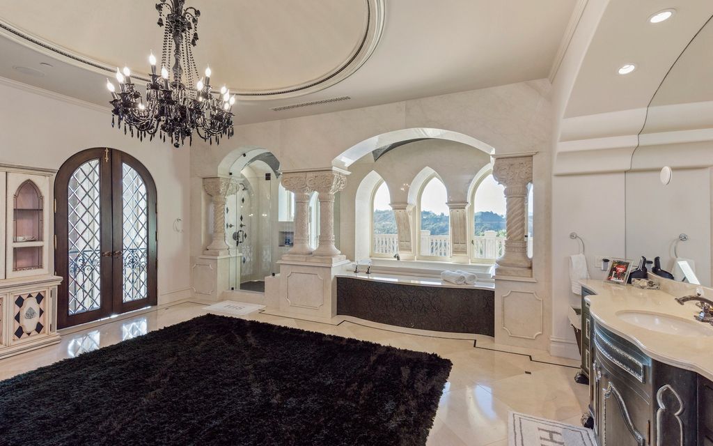 9 Beverly Ridge Terrace Home in Beverly Hills, California. Nestled behind double guard gates in the prestigious Beverly Ridge Estates, this custom-built Italian Romanticism-inspired home boasts modern-day conveniences while showcasing the intricately designed craftsmanship of renowned architect, Robert Rivani.