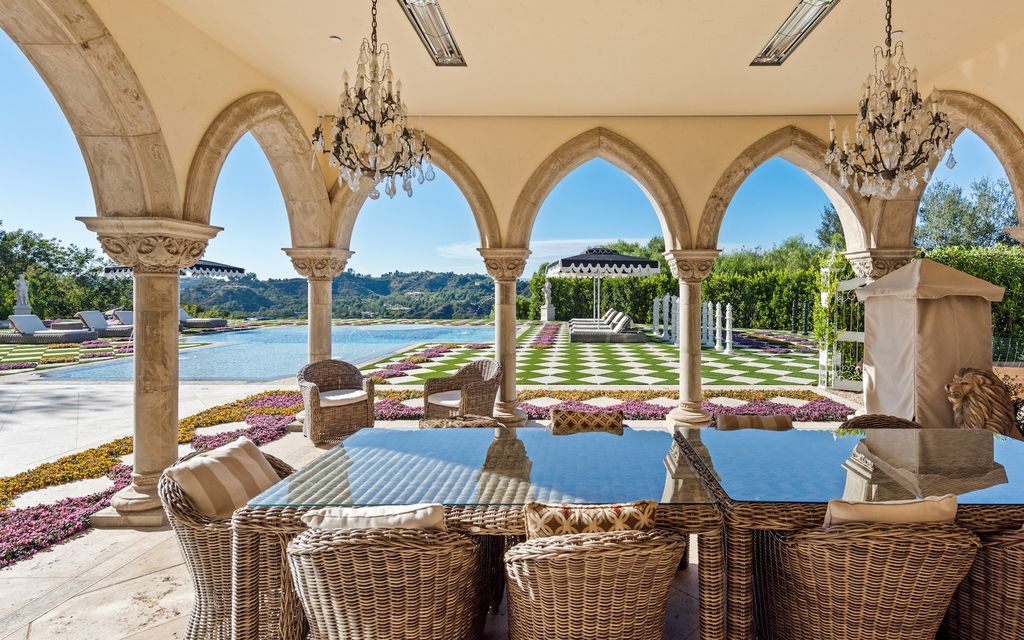 9 Beverly Ridge Terrace Home in Beverly Hills, California. Nestled behind double guard gates in the prestigious Beverly Ridge Estates, this custom-built Italian Romanticism-inspired home boasts modern-day conveniences while showcasing the intricately designed craftsmanship of renowned architect, Robert Rivani.
