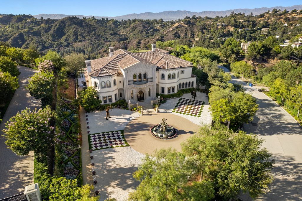 9 Beverly Ridge Terrace Home in Beverly Hills, California. Nestled behind double guard gates in the prestigious Beverly Ridge Estates, this custom-built Italian Romanticism-inspired home boasts modern-day conveniences while showcasing the intricately designed craftsmanship of renowned architect, Robert Rivani.