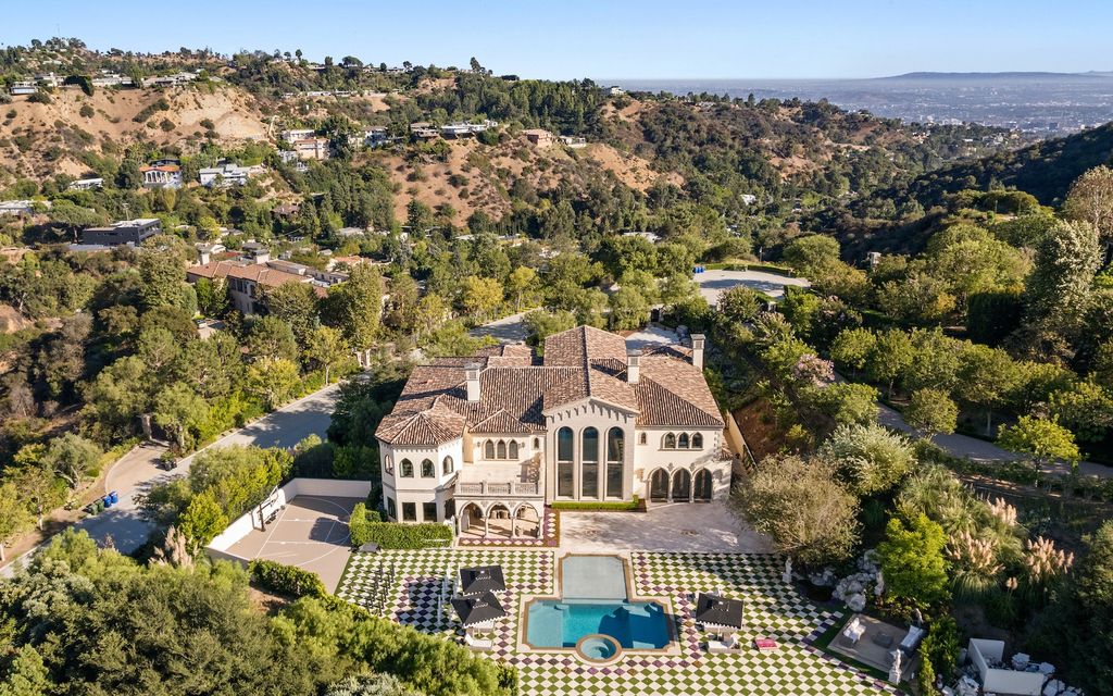 9 Beverly Ridge Terrace Home in Beverly Hills, California. Nestled behind double guard gates in the prestigious Beverly Ridge Estates, this custom-built Italian Romanticism-inspired home boasts modern-day conveniences while showcasing the intricately designed craftsmanship of renowned architect, Robert Rivani.
