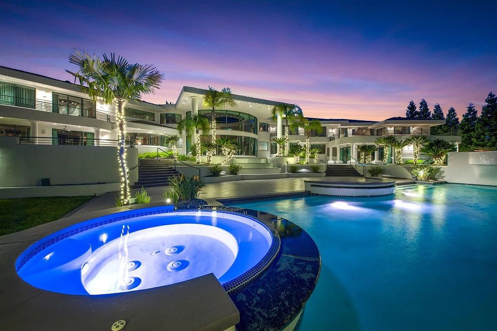 9125 Vista De Lago Court Home in Granite Bay, California. This grand estate is located at the highest point of Los Lagos, providing breathtaking views of Folsom Lake, the Sierra Nevada Mountains, and the Sacramento skyline. The main house boasts over 11,500 square feet while the guest house offers an additional 5,200 square feet.