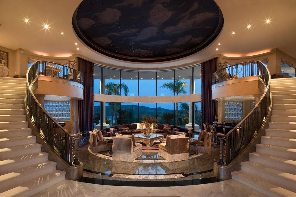 9125 Vista De Lago Court Home in Granite Bay, California. This grand estate is located at the highest point of Los Lagos, providing breathtaking views of Folsom Lake, the Sierra Nevada Mountains, and the Sacramento skyline. The main house boasts over 11,500 square feet while the guest house offers an additional 5,200 square feet.