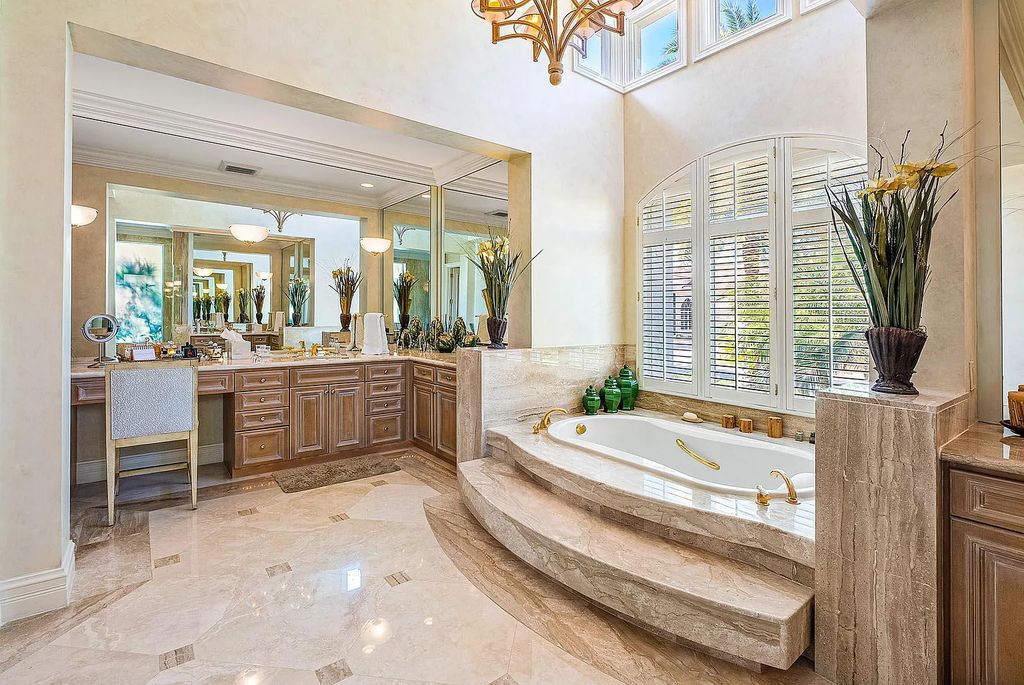 Discover unparalleled beauty in this prestigious waterfront estate located at 174 W Coconut Palm Road, Boca Raton's Royal Palm Yacht & Country Club, Florida. With captivating waterway views, this architectural marvel offers a tropical oasis on over half an acre of lush greenery.