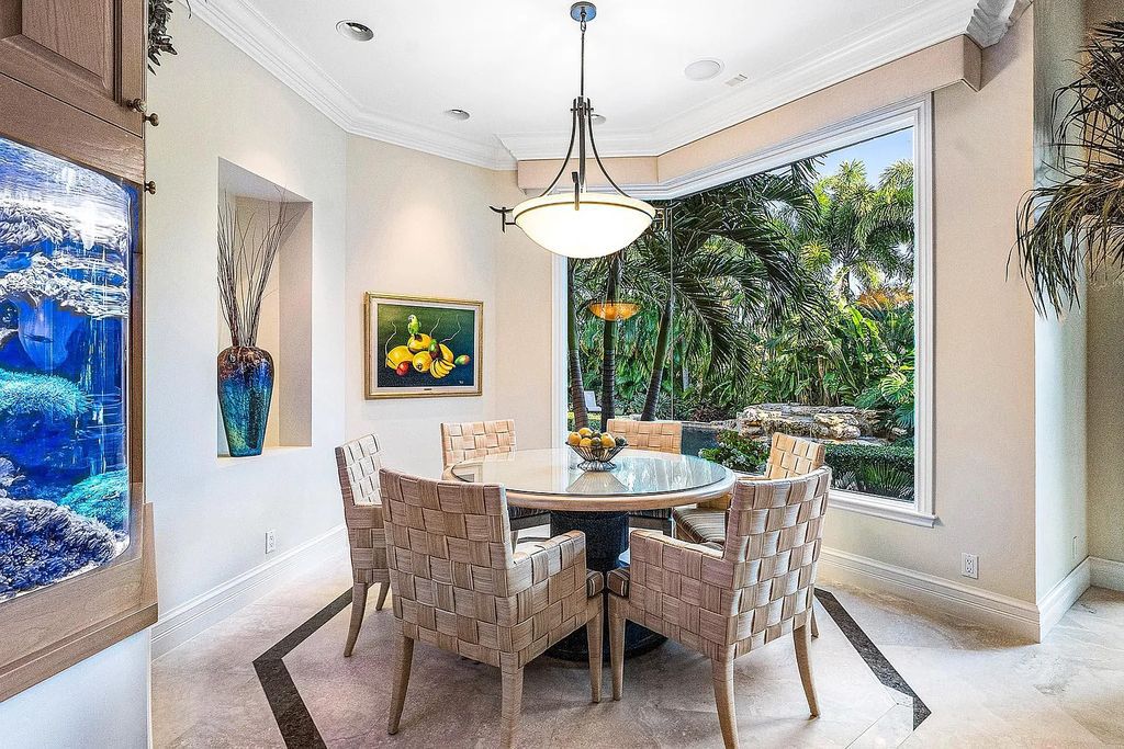 Discover unparalleled beauty in this prestigious waterfront estate located at 174 W Coconut Palm Road, Boca Raton's Royal Palm Yacht & Country Club, Florida. With captivating waterway views, this architectural marvel offers a tropical oasis on over half an acre of lush greenery.