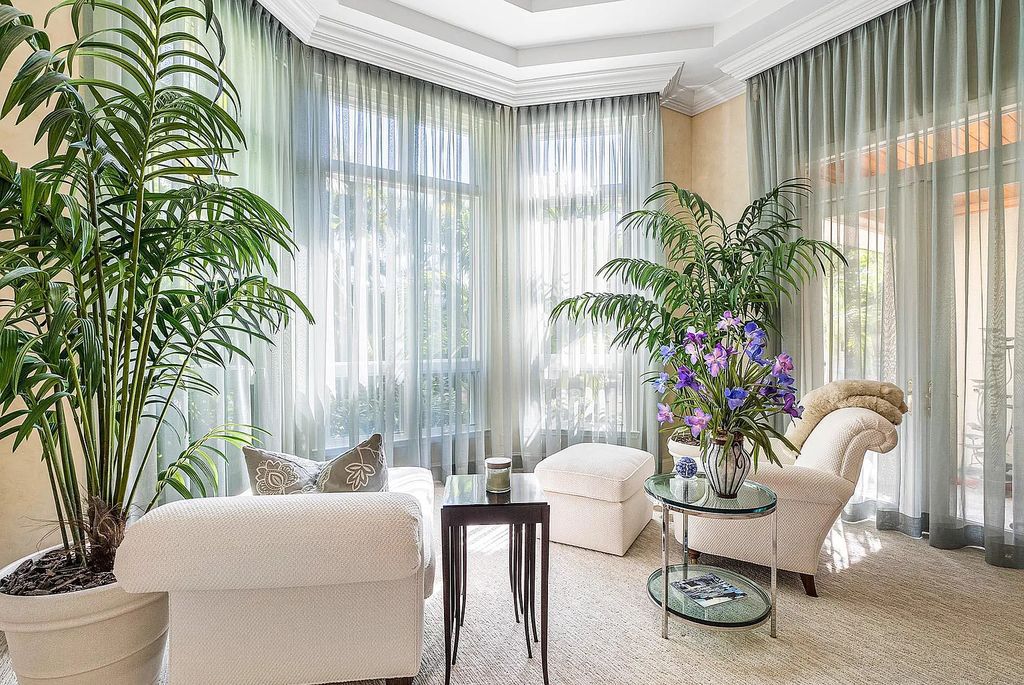 Discover unparalleled beauty in this prestigious waterfront estate located at 174 W Coconut Palm Road, Boca Raton's Royal Palm Yacht & Country Club, Florida. With captivating waterway views, this architectural marvel offers a tropical oasis on over half an acre of lush greenery.