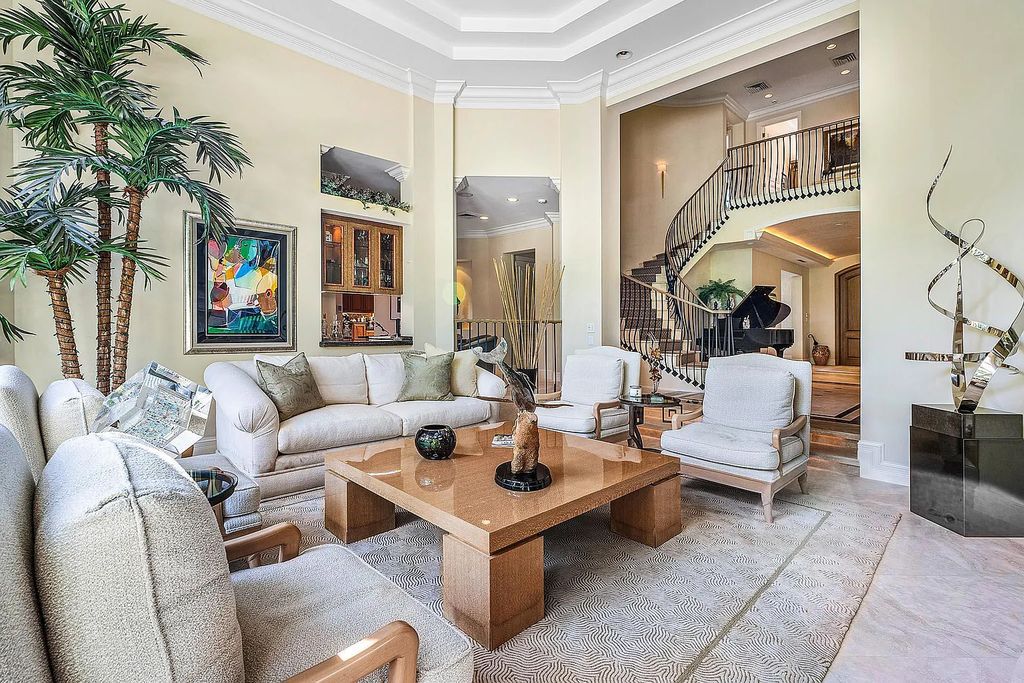Discover unparalleled beauty in this prestigious waterfront estate located at 174 W Coconut Palm Road, Boca Raton's Royal Palm Yacht & Country Club, Florida. With captivating waterway views, this architectural marvel offers a tropical oasis on over half an acre of lush greenery.