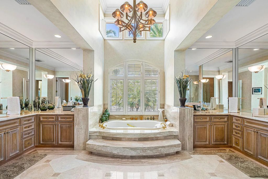 Discover unparalleled beauty in this prestigious waterfront estate located at 174 W Coconut Palm Road, Boca Raton's Royal Palm Yacht & Country Club, Florida. With captivating waterway views, this architectural marvel offers a tropical oasis on over half an acre of lush greenery.