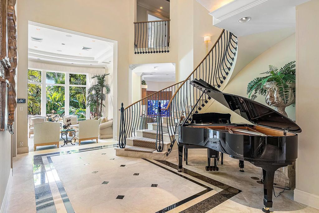 Discover unparalleled beauty in this prestigious waterfront estate located at 174 W Coconut Palm Road, Boca Raton's Royal Palm Yacht & Country Club, Florida. With captivating waterway views, this architectural marvel offers a tropical oasis on over half an acre of lush greenery.