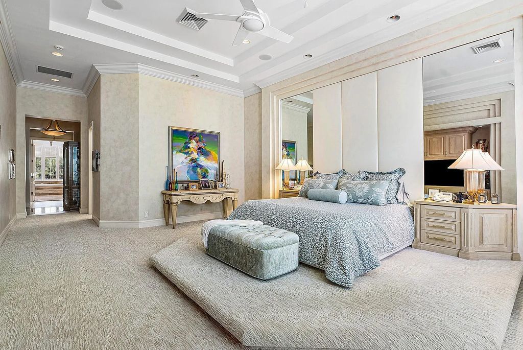 Discover unparalleled beauty in this prestigious waterfront estate located at 174 W Coconut Palm Road, Boca Raton's Royal Palm Yacht & Country Club, Florida. With captivating waterway views, this architectural marvel offers a tropical oasis on over half an acre of lush greenery.