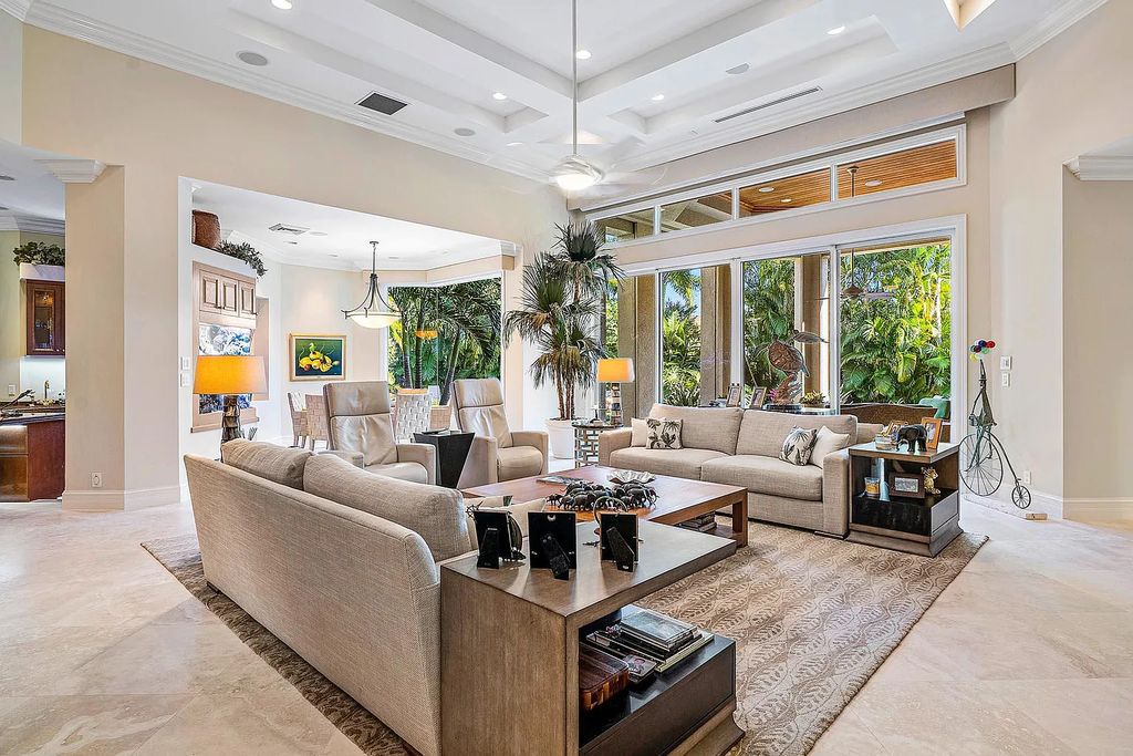Discover unparalleled beauty in this prestigious waterfront estate located at 174 W Coconut Palm Road, Boca Raton's Royal Palm Yacht & Country Club, Florida. With captivating waterway views, this architectural marvel offers a tropical oasis on over half an acre of lush greenery.