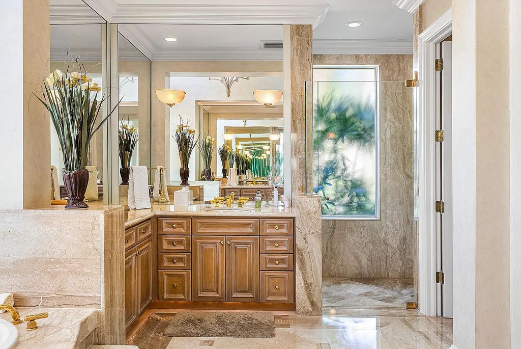 Discover unparalleled beauty in this prestigious waterfront estate located at 174 W Coconut Palm Road, Boca Raton's Royal Palm Yacht & Country Club, Florida. With captivating waterway views, this architectural marvel offers a tropical oasis on over half an acre of lush greenery.