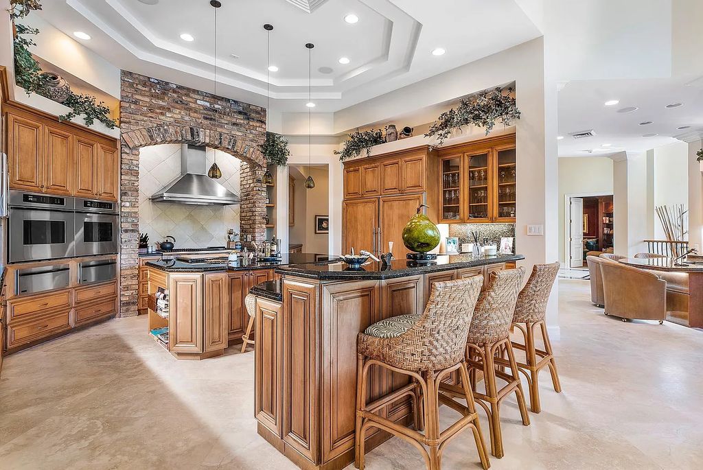 Discover unparalleled beauty in this prestigious waterfront estate located at 174 W Coconut Palm Road, Boca Raton's Royal Palm Yacht & Country Club, Florida. With captivating waterway views, this architectural marvel offers a tropical oasis on over half an acre of lush greenery.