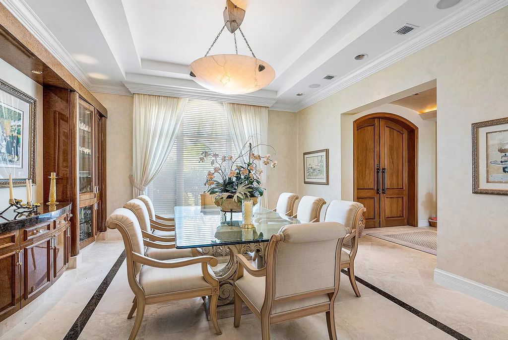 Discover unparalleled beauty in this prestigious waterfront estate located at 174 W Coconut Palm Road, Boca Raton's Royal Palm Yacht & Country Club, Florida. With captivating waterway views, this architectural marvel offers a tropical oasis on over half an acre of lush greenery.