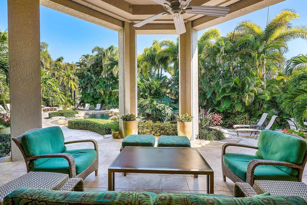 Discover unparalleled beauty in this prestigious waterfront estate located at 174 W Coconut Palm Road, Boca Raton's Royal Palm Yacht & Country Club, Florida. With captivating waterway views, this architectural marvel offers a tropical oasis on over half an acre of lush greenery.