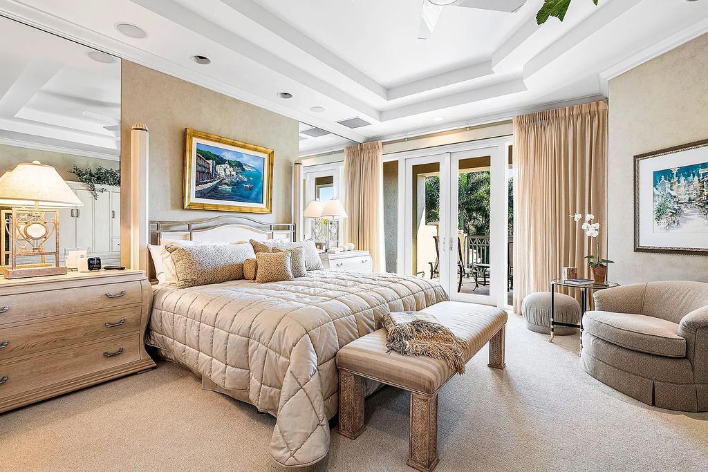 Discover unparalleled beauty in this prestigious waterfront estate located at 174 W Coconut Palm Road, Boca Raton's Royal Palm Yacht & Country Club, Florida. With captivating waterway views, this architectural marvel offers a tropical oasis on over half an acre of lush greenery.