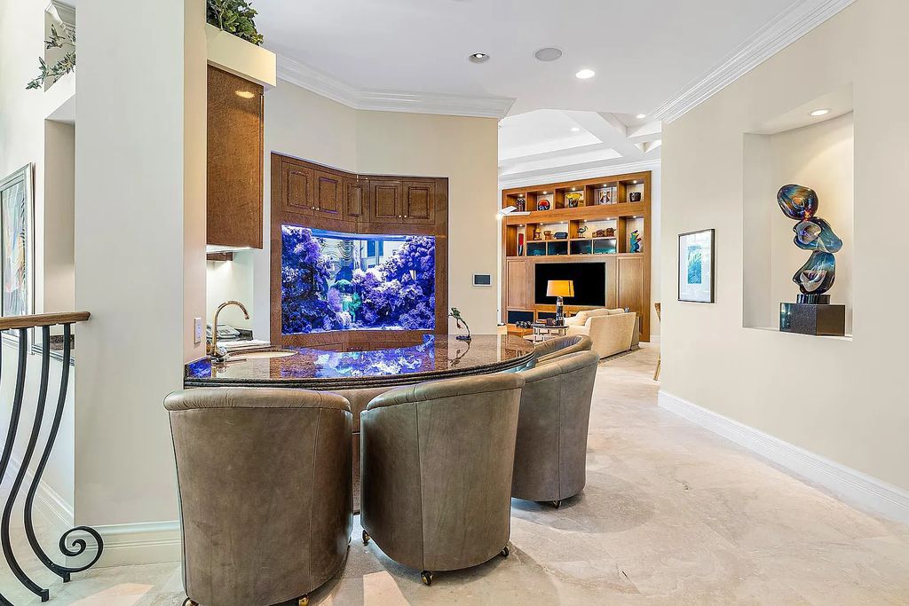 Discover unparalleled beauty in this prestigious waterfront estate located at 174 W Coconut Palm Road, Boca Raton's Royal Palm Yacht & Country Club, Florida. With captivating waterway views, this architectural marvel offers a tropical oasis on over half an acre of lush greenery.