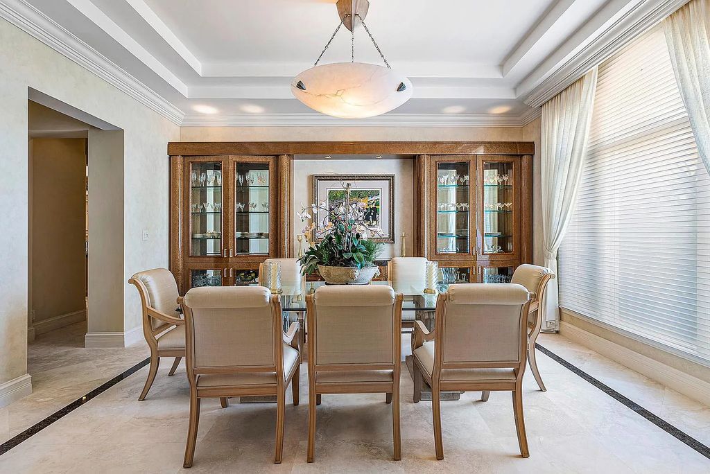 Discover unparalleled beauty in this prestigious waterfront estate located at 174 W Coconut Palm Road, Boca Raton's Royal Palm Yacht & Country Club, Florida. With captivating waterway views, this architectural marvel offers a tropical oasis on over half an acre of lush greenery.