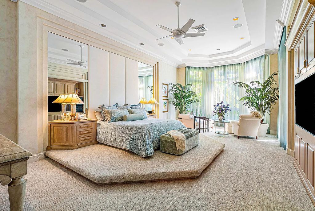 Discover unparalleled beauty in this prestigious waterfront estate located at 174 W Coconut Palm Road, Boca Raton's Royal Palm Yacht & Country Club, Florida. With captivating waterway views, this architectural marvel offers a tropical oasis on over half an acre of lush greenery.