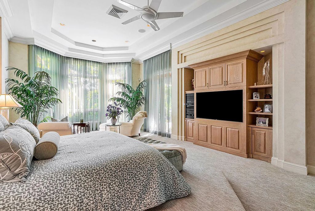 Discover unparalleled beauty in this prestigious waterfront estate located at 174 W Coconut Palm Road, Boca Raton's Royal Palm Yacht & Country Club, Florida. With captivating waterway views, this architectural marvel offers a tropical oasis on over half an acre of lush greenery.