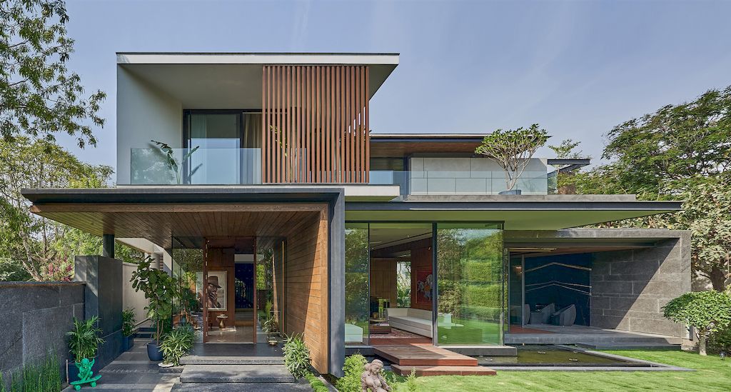 Corner House Connected to Well-landscaped Outdoors by DADA Partners