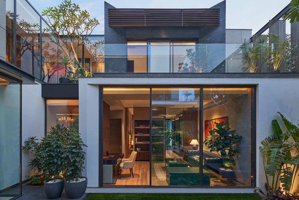 Corner House Connected to Well-landscaped Outdoors by DADA Partners