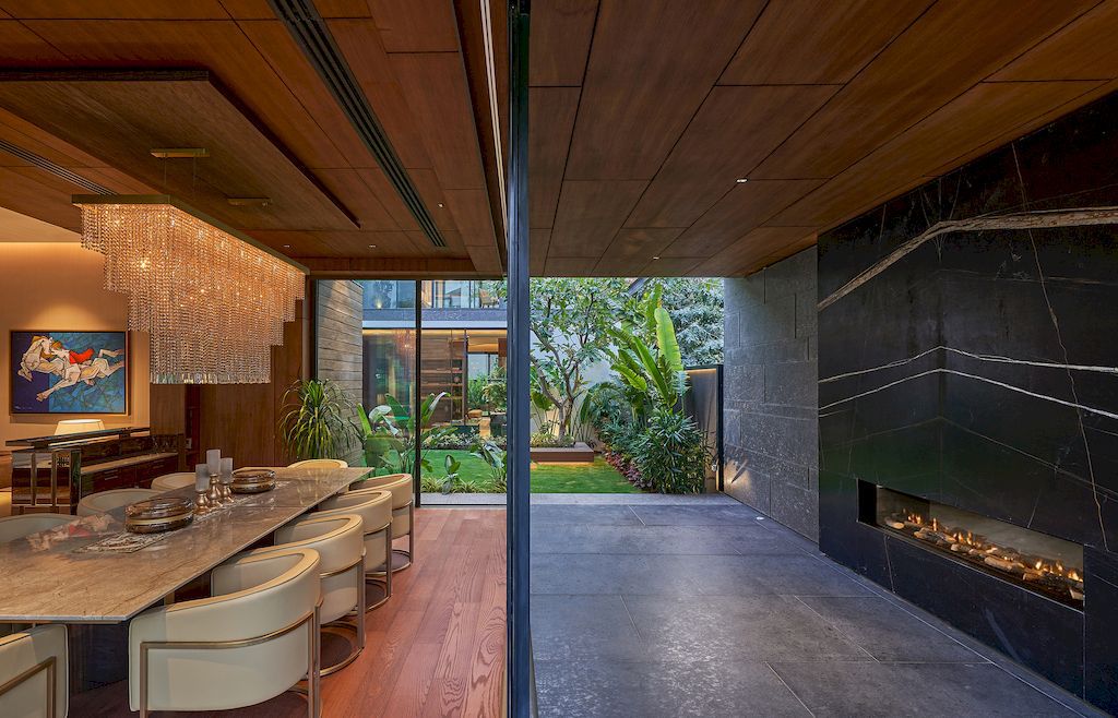 Corner House Connected to Well-landscaped Outdoors by DADA Partners