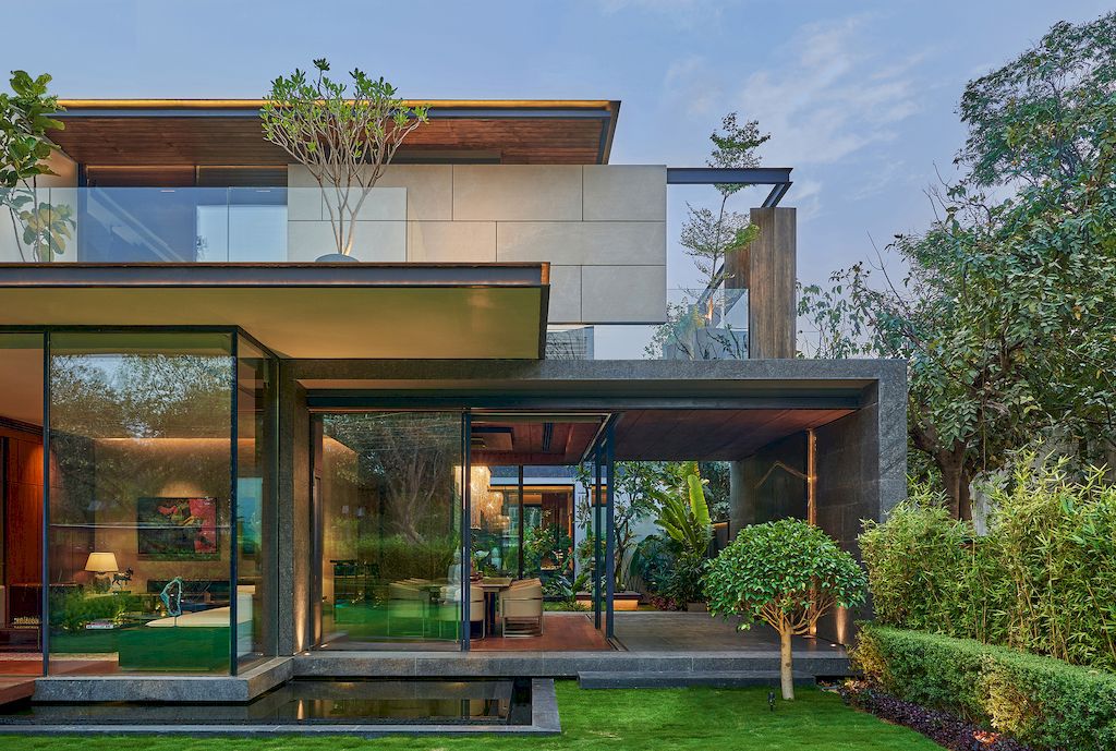 Corner House Connected to Well-landscaped Outdoors by DADA Partners