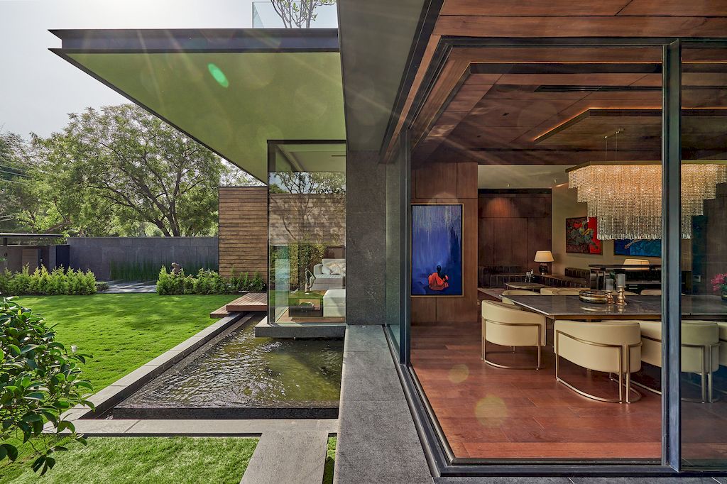 Corner House Connected to Well-landscaped Outdoors by DADA Partners
