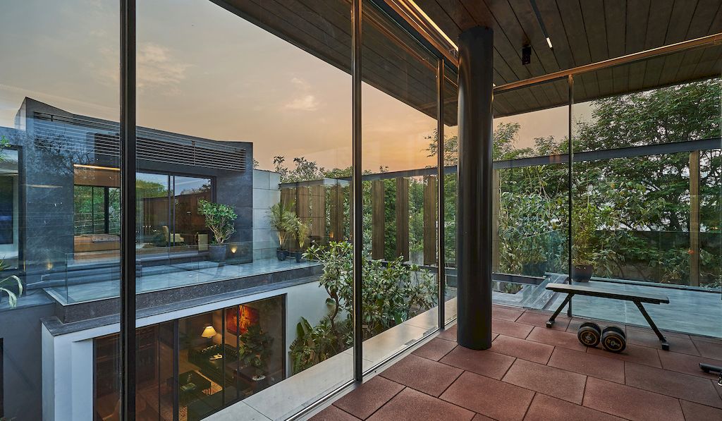 Corner House Connected to Well-landscaped Outdoors by DADA Partners