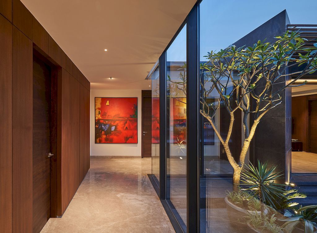 Corner House Connected to Well-landscaped Outdoors by DADA Partners