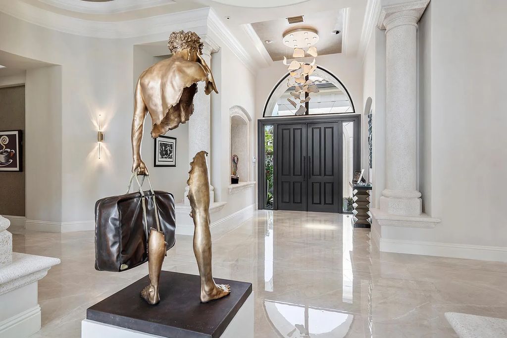 Experience the epitome of luxury living at 420 E Coconut Palm Road, Boca Raton, Florida. This meticulously renovated waterfront estate showcases 7 beds, 9 baths, and 7,216 sq ft of opulent living space.