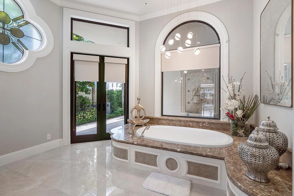 Experience the epitome of luxury living at 420 E Coconut Palm Road, Boca Raton, Florida. This meticulously renovated waterfront estate showcases 7 beds, 9 baths, and 7,216 sq ft of opulent living space.