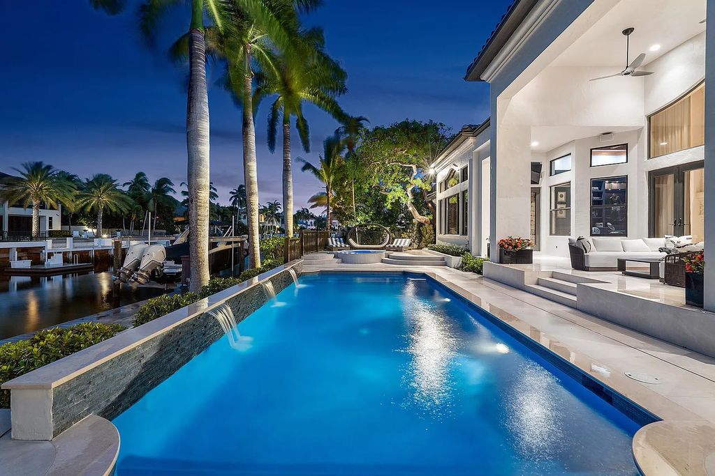 Experience the epitome of luxury living at 420 E Coconut Palm Road, Boca Raton, Florida. This meticulously renovated waterfront estate showcases 7 beds, 9 baths, and 7,216 sq ft of opulent living space.