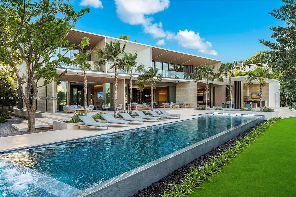 Presenting 98 La Gorce Circle, Miami Beach, Florida an extraordinary Villa Arte by Aquablue Group on Miami Beach's exclusive La Gorce Island. This stunning 7-bedrooms, 13-bathrooms residence spans 14,060 square feet, situated on a 0.76-acre lot.