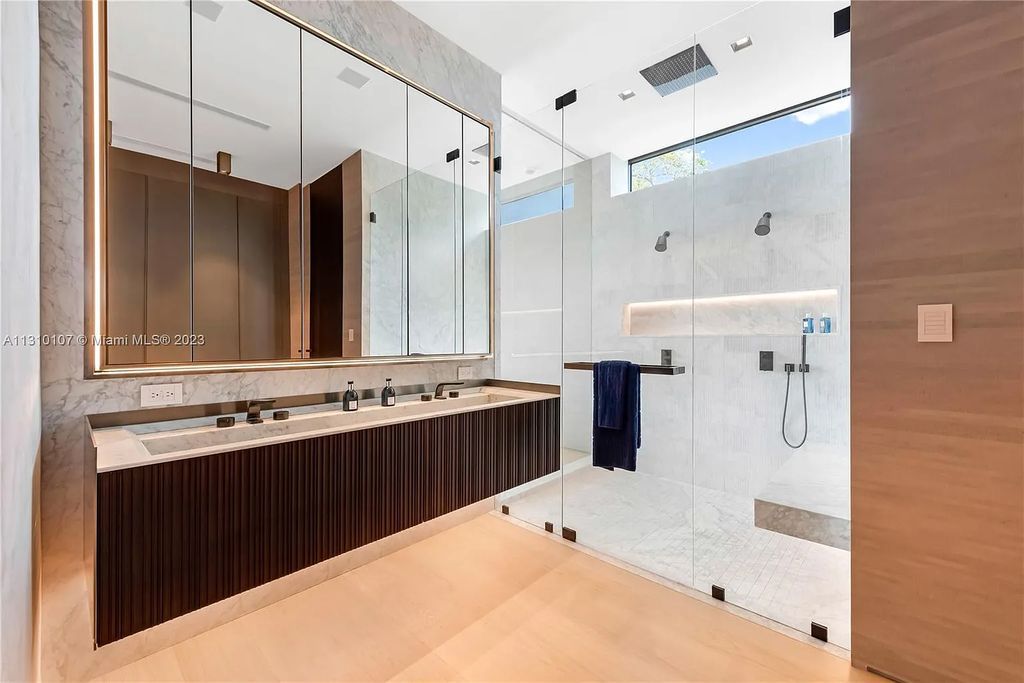 Presenting 98 La Gorce Circle, Miami Beach, Florida an extraordinary Villa Arte by Aquablue Group on Miami Beach's exclusive La Gorce Island. This stunning 7-bedrooms, 13-bathrooms residence spans 14,060 square feet, situated on a 0.76-acre lot.