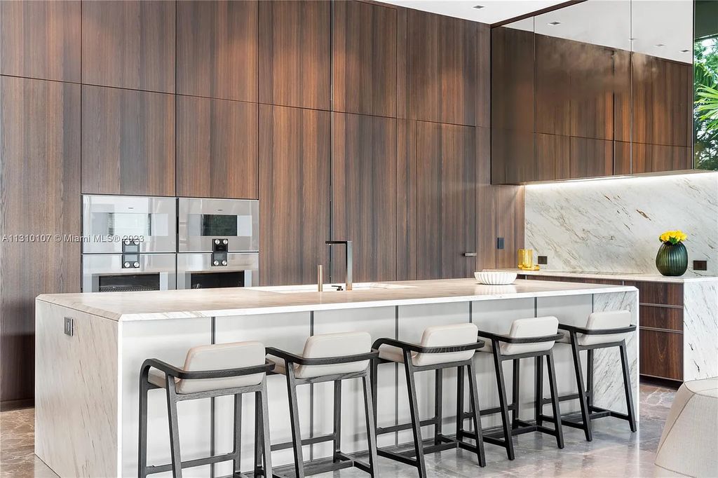 Presenting 98 La Gorce Circle, Miami Beach, Florida an extraordinary Villa Arte by Aquablue Group on Miami Beach's exclusive La Gorce Island. This stunning 7-bedrooms, 13-bathrooms residence spans 14,060 square feet, situated on a 0.76-acre lot.