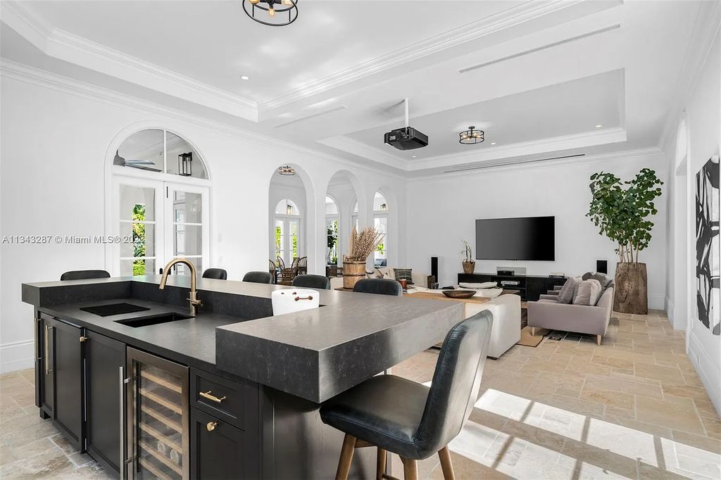 Experience luxurious waterfront living at 365 Arvida Pkwy, Coral Gables, Florida. This 11,946 sq ft masterpiece in Gables Estates offers 8 bedrooms, 11 baths, and 180 ft of waterfrontage. The main suite features a private balcony, spa-like bathroom, and walk-in closets.