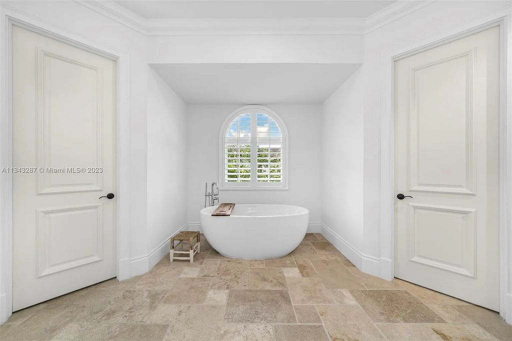 Experience luxurious waterfront living at 365 Arvida Pkwy, Coral Gables, Florida. This 11,946 sq ft masterpiece in Gables Estates offers 8 bedrooms, 11 baths, and 180 ft of waterfrontage. The main suite features a private balcony, spa-like bathroom, and walk-in closets.