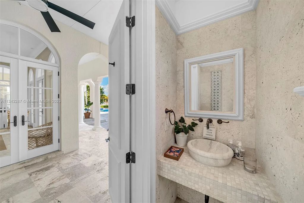 Experience luxurious waterfront living at 365 Arvida Pkwy, Coral Gables, Florida. This 11,946 sq ft masterpiece in Gables Estates offers 8 bedrooms, 11 baths, and 180 ft of waterfrontage. The main suite features a private balcony, spa-like bathroom, and walk-in closets.