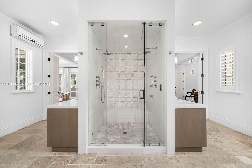 Experience luxurious waterfront living at 365 Arvida Pkwy, Coral Gables, Florida. This 11,946 sq ft masterpiece in Gables Estates offers 8 bedrooms, 11 baths, and 180 ft of waterfrontage. The main suite features a private balcony, spa-like bathroom, and walk-in closets.