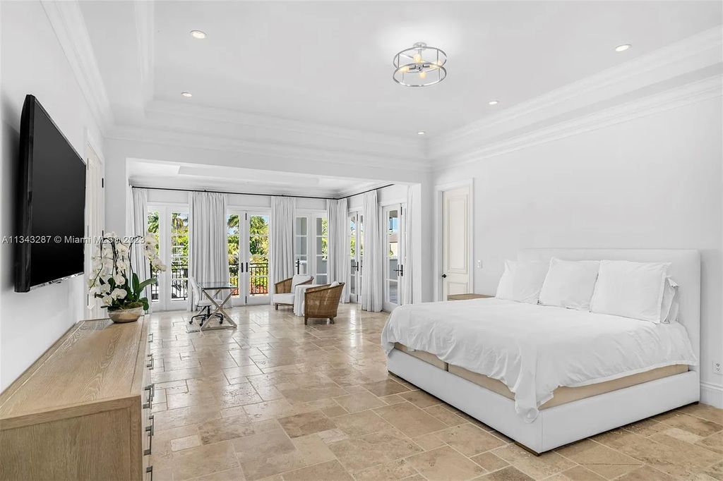 Experience luxurious waterfront living at 365 Arvida Pkwy, Coral Gables, Florida. This 11,946 sq ft masterpiece in Gables Estates offers 8 bedrooms, 11 baths, and 180 ft of waterfrontage. The main suite features a private balcony, spa-like bathroom, and walk-in closets.