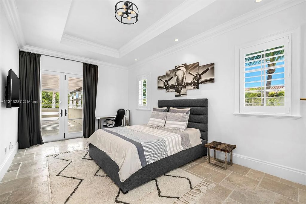 Experience luxurious waterfront living at 365 Arvida Pkwy, Coral Gables, Florida. This 11,946 sq ft masterpiece in Gables Estates offers 8 bedrooms, 11 baths, and 180 ft of waterfrontage. The main suite features a private balcony, spa-like bathroom, and walk-in closets.