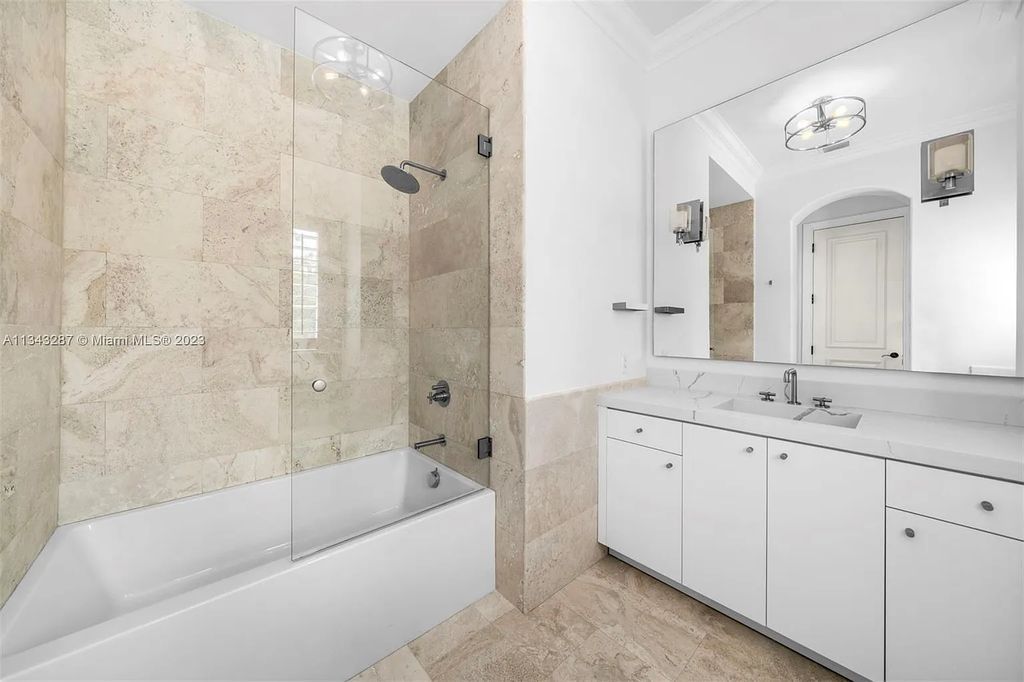 Experience luxurious waterfront living at 365 Arvida Pkwy, Coral Gables, Florida. This 11,946 sq ft masterpiece in Gables Estates offers 8 bedrooms, 11 baths, and 180 ft of waterfrontage. The main suite features a private balcony, spa-like bathroom, and walk-in closets.