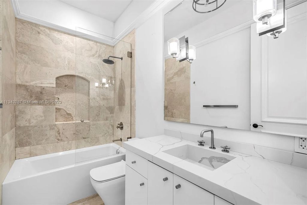 Experience luxurious waterfront living at 365 Arvida Pkwy, Coral Gables, Florida. This 11,946 sq ft masterpiece in Gables Estates offers 8 bedrooms, 11 baths, and 180 ft of waterfrontage. The main suite features a private balcony, spa-like bathroom, and walk-in closets.